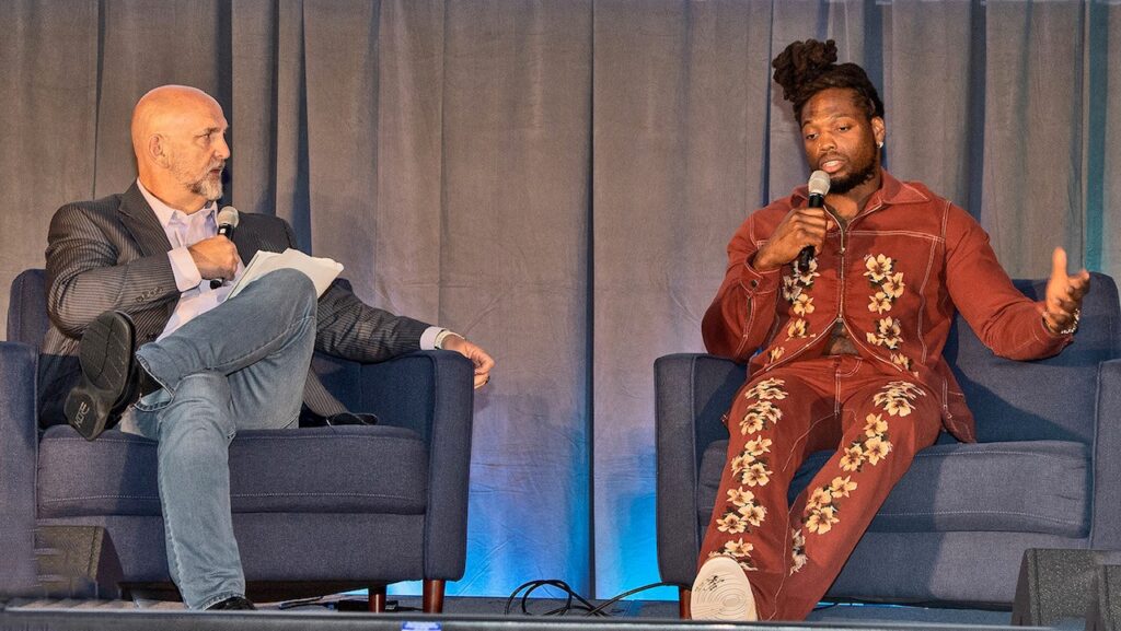 fireside chat with two individuals sitting in chairs