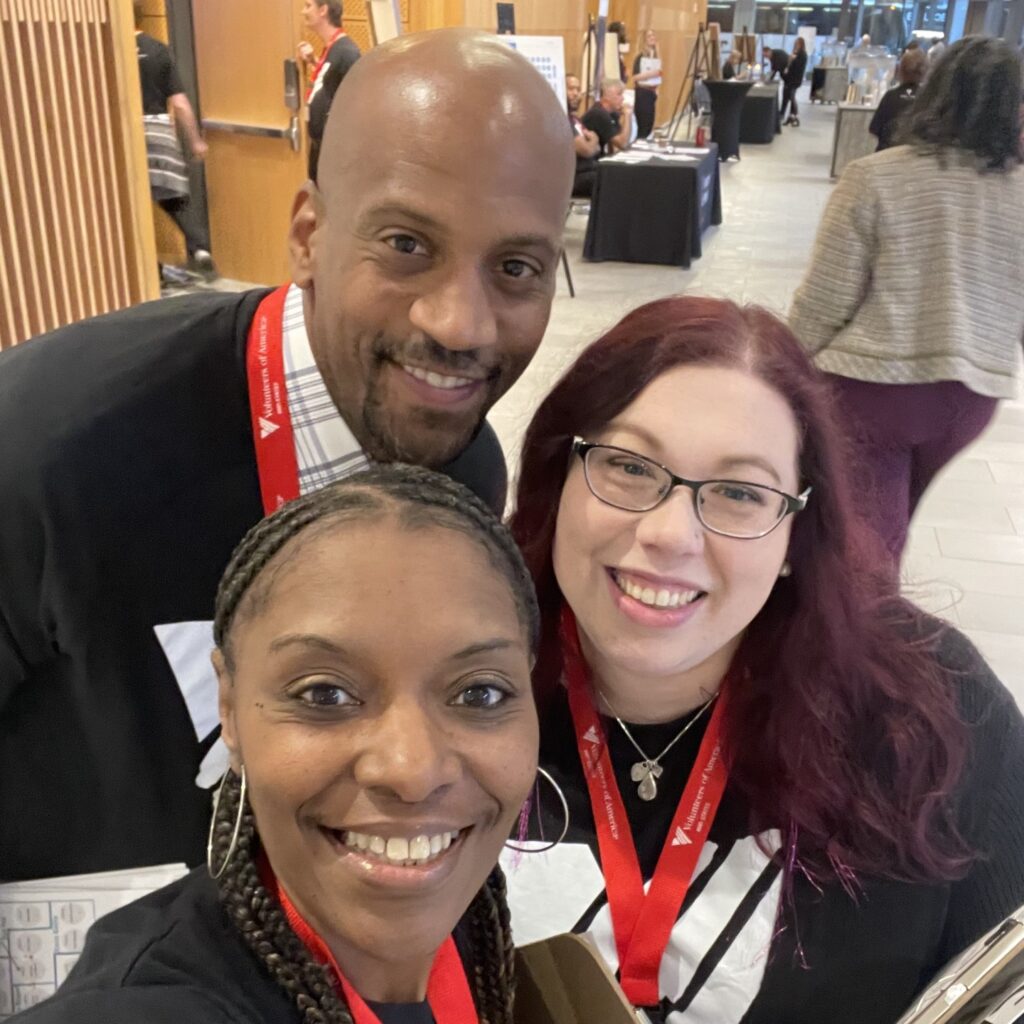 three employees take a selfie