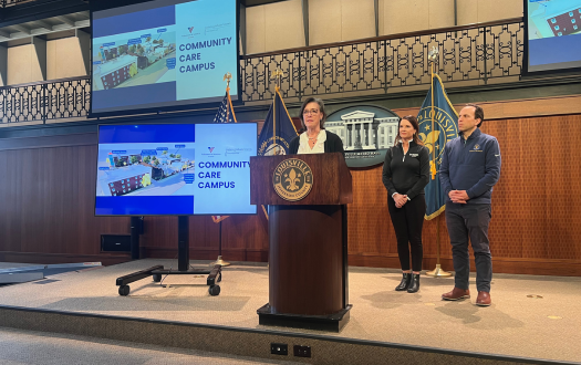 James Graham Brown Foundation CEO, Mason Rummel, stands at podium to announce funding toward VOA's Community Care Campus.