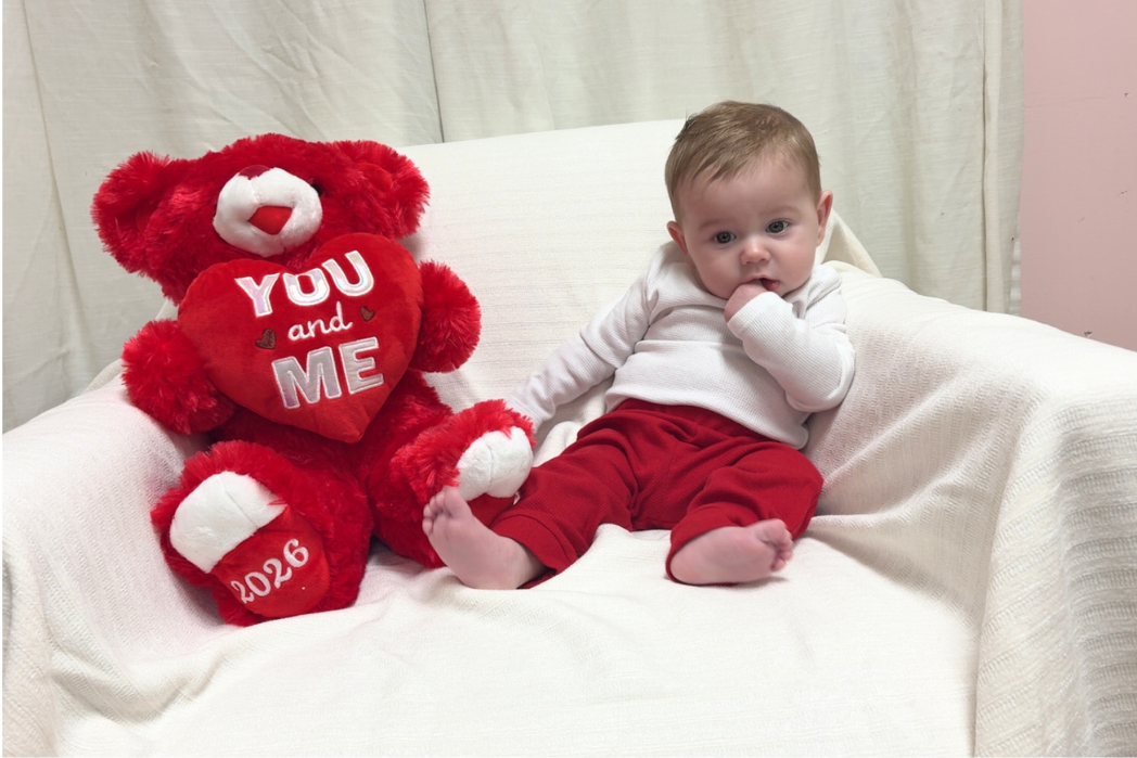 Freedom House baby, Chance, in his Valentine's Day outfit with a cute teddy bear.